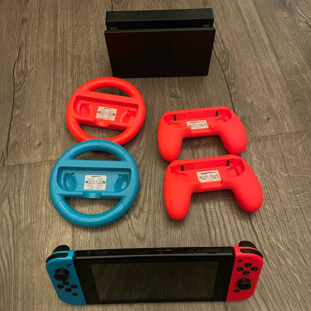 Nintendo Switch with Red and Blue Joy‑Con Controllers and Racing Grips and dock